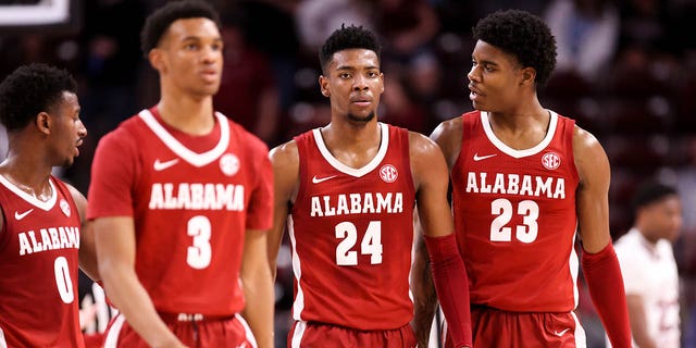 Nick Pringle, #23, talks to Brandon Miller, #24, of the Alabama Crimson Tide as they walk back to the bench during a basketball game against the South Carolina Gamecocks on Feb. 22, 2023 at Colonial Life Arena in Columbia, South Carolina.