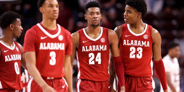 Nick Pringle, #23, talks to Brandon Miller, #24, of the Alabama Crimson Tide as they walk back to the bench during a basketball game against the South Carolina Gamecocks on Feb. 22, 2023 at Colonial Life Arena in Columbia, South Carolina.
