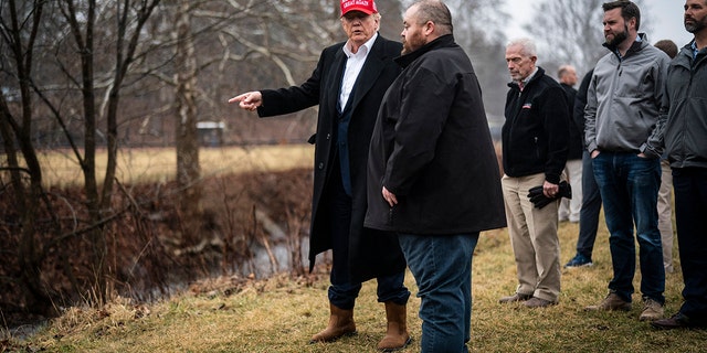 Former President Donald Trump looks at Little Beaver Creek and Water Pumps as he visits East Palestine, Ohio, following the Feb. 3 Norfolk Southern freight train derailment on Wednesday, Feb. 22, 2023, in East Palestine, Ohio. 