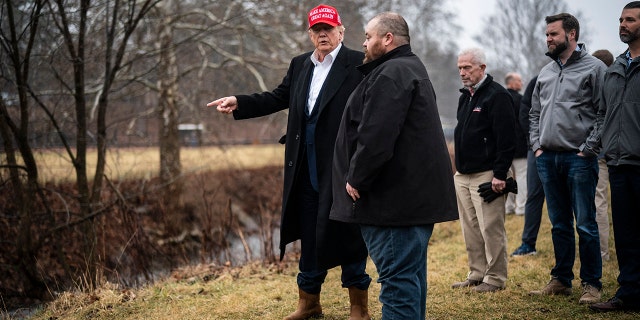 Former President Donald Trump looks at Little Beaver Creek and Water Pumps as he visits East Palestine, Ohio, following the Feb. 3 Norfolk Southern freight train derailment on Wednesday, Feb. 22, 2023, in East Palestine, Ohio. 