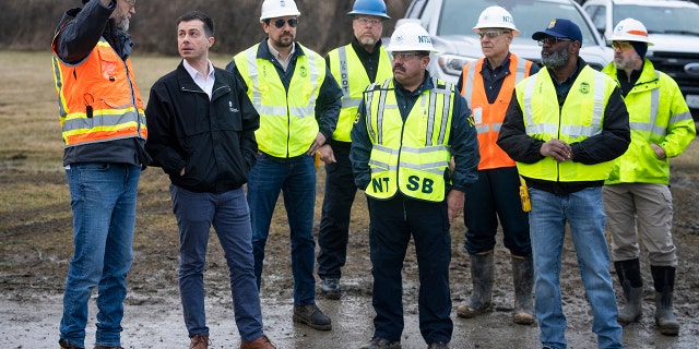 U.S. Secretary of Transportation Pete Buttigieg (2L) visits with Department of Transportation Investigators at the site of the derailment on February 23, 2023, in East Palestine, Ohio. 