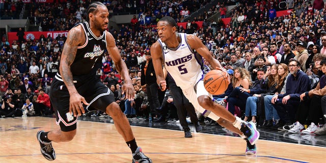 De'Aaron Fox, #5 of the Sacramento Kings, dribbles the ball during the game against the LA Clippers on February 24, 2023, at Crypto.Com Arena in Los Angeles, California.