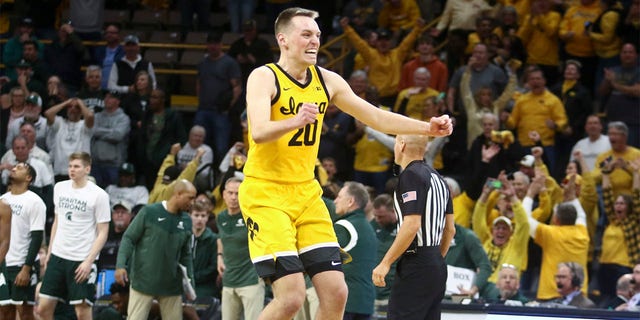 Forward Payton Sandfort, #20 of the Iowa Hawkeyes, celebrates after hitting a game tying three-point basket in the second half to force overtime against the Michigan State Spartans at Carver-Hawkeye Arena, on February 25, 2023, in Iowa City, Iowa.  