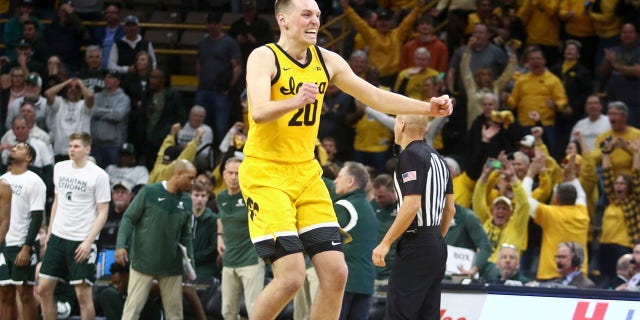 Forward Payton Sandfort, #20 of the Iowa Hawkeyes, celebrates after hitting a game tying three-point basket in the second half to force overtime against the Michigan State Spartans at Carver-Hawkeye Arena, on February 25, 2023, in Iowa City, Iowa.  