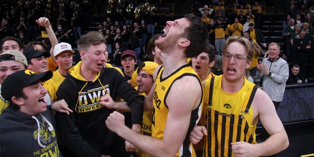 Forward Filip Rebraca, #0 of the Iowa Hawkeyes, celebrates with the student section after the overtime victory against the Michigan State Spartans at Carver-Hawkeye Arena, on February 25, 2023, in Iowa City, Iowa.  