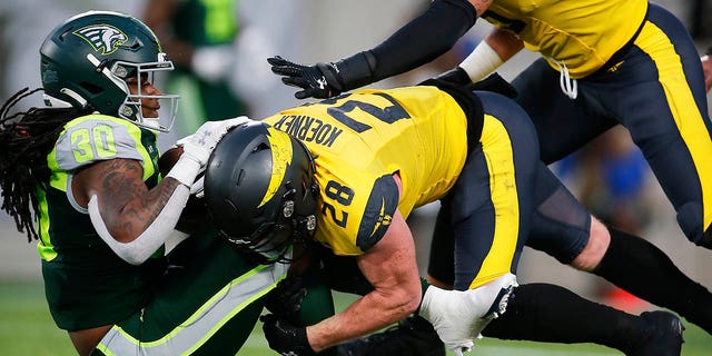 Guardians running back Jah-Maine Martin is tackled for a loss by San Antonio Brahmas defensive back Jack Koerner on Feb. 26, 2023, at Camping World Stadium in Orlando, Florida.