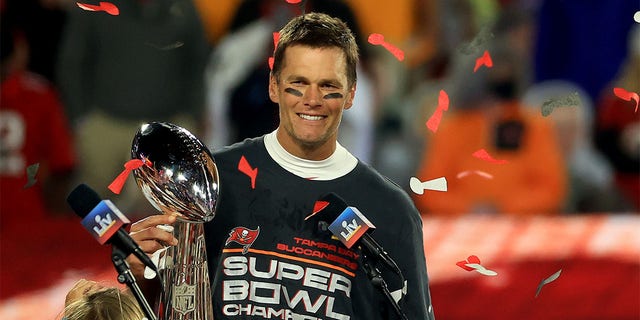 Tom Brady of the Buccaneers raises the Vince Lombardi Trophy after winning Super Bowl LV at Raymond James Stadium on February 7, 2021 in Tampa, Florida.