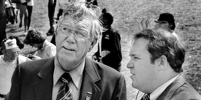 NASCAR founder and former CEO Bill France Sr., left, talks with a U.S. Secret Service agent regarding security for Vice President George H.W. Bush prior to the start of the 1983 Daytona 500 stock car race at Daytona International Speedway in Daytona Beach. Bush served as the race's honorary starter.