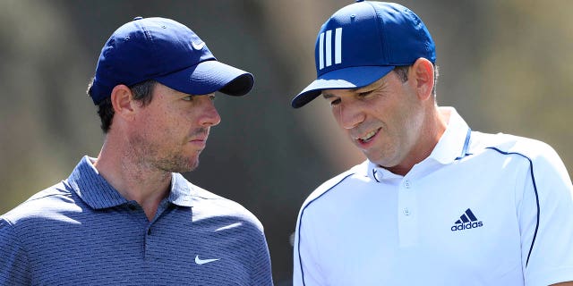 Rory McIlroy, left, talks to Sergio Garcia during the first round of THE PLAYERS Championship on THE PLAYERS Stadium Course at TPC Sawgrass on March 11, 2021 in Ponte Vedra Beach, Florida.