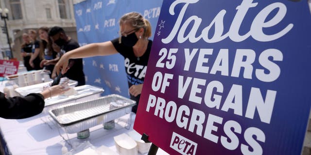 Volunteers serve vegan hot dogs at the PETA Congressional Veggie Dog Lunch outside the Longworth House Office Building July 21, 2021, in Washington, DC.