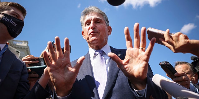 Sen. Joe Manchin speaks to reporters outside the Capitol on Sept. 30, 2021.