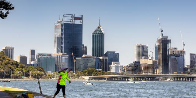 A lady throws a crab net out from the banks of the Swan River on January 22, 2022 in Perth, Australia.