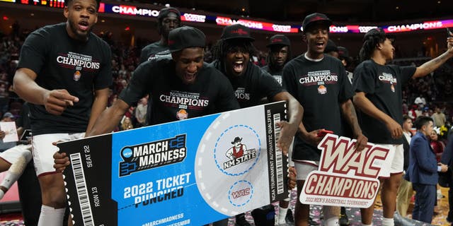 The New Mexico State Aggies celebrate after winning the championship game of the Western Athletic Conference basketball tournament against the Abilene Christian Wildcats at the Orleans Arena on March 12, 2022, in Las Vegas, Nevada.