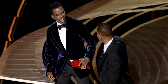 At the 2022 Oscars, Will Smith, right, slapped Chris Rock after the comedian made a joke about Smith's wife, Jada Pinkett Smith, and her bald head. Smith was later banned from the Oscars for 10 years.