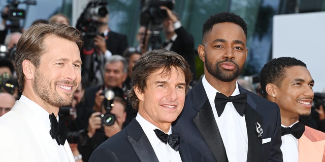 Glen Powell, Tom Cruise, Jay Ellis and Greg Tarzan Davis attend the screening of "Top Gun: Maverick" during the 75th annual Cannes Film Festival at Palais des Festivals on May 18, 2022. 
