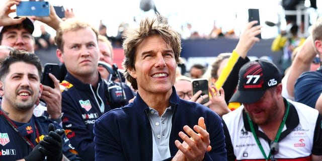 Tom Cruise applauds at the Podium celebrations during the F1 Grand Prix of Great Britain at Silverstone on July 3, 2022, in Northampton, England.