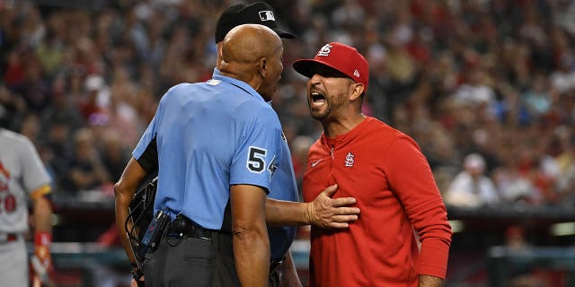 Manager Oliver Marmol of the St. Louis Cardinals, right, argues with home plate umpire C.B. Bucknor after being ejected during the third inning of a game against the Arizona Diamondbacks at Chase Field on Aug. 21, 2022, in Phoenix.