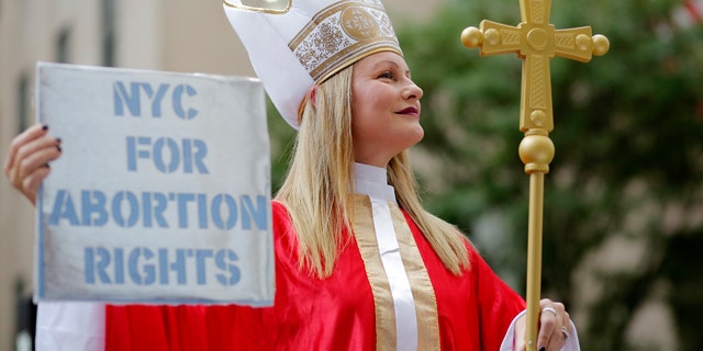 A woman in a Catholic cardinal costume attends the Abortion Carnival at St. Patrick's Cathedral on September 26, 2022 in New York City. 