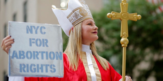 A woman in a Catholic cardinal costume attends the Abortion Carnival at St. Patrick's Cathedral on September 26, 2022 in New York City. 