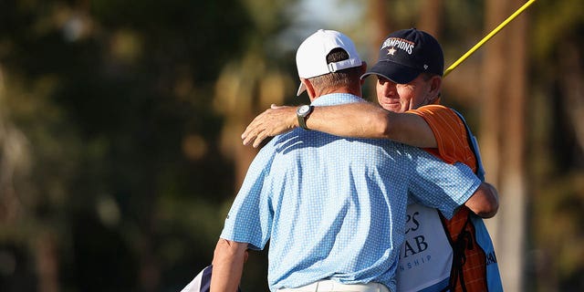 Steven Alker of New Zealand embraces caddy Sam Workman after winning the Charles Schwab Cup after the final round of the Charles Schwab Cup Championship at Phoenix Country Club on November 13, 2022 in Phoenix, Arizona.