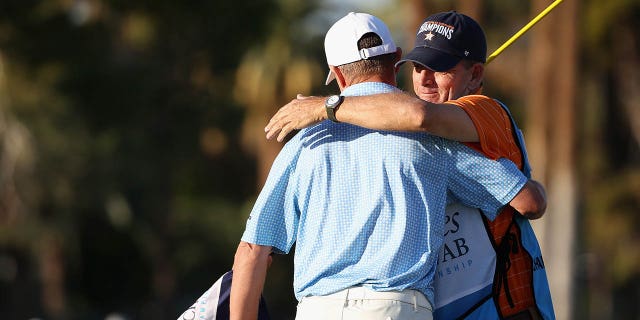 Steven Alker of New Zealand hugs caddy Sam Workman after winning the Charles Schwab Cup following the final round of the Charles Schwab Cup Championship at Phoenix Country Club on November 13, 2022 in Phoenix.