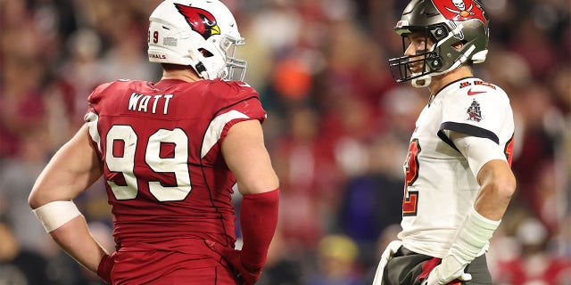 Cardinals defensive end J.J. Watt talks with quarterback Tom Brady of the Tampa Bay Buccaneers at State Farm Stadium on Dec. 25, 2022, in Glendale, Arizona.