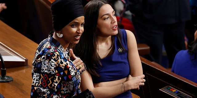 Rep. Ilhan Omar, D-Minn., and Rep. Alexandria Ocasio-Cortez, D-NY, talk in the House Chamber at the U.S. Capitol Building on January 03, 2023, in Washington, DC. 
