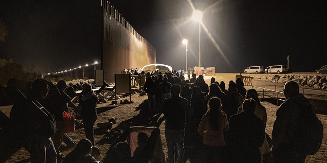 Immigrants wait to be processed by the U.S. Border Patrol after crossing the border from Mexico on December 30, 2022, in Yuma, Arizona. 