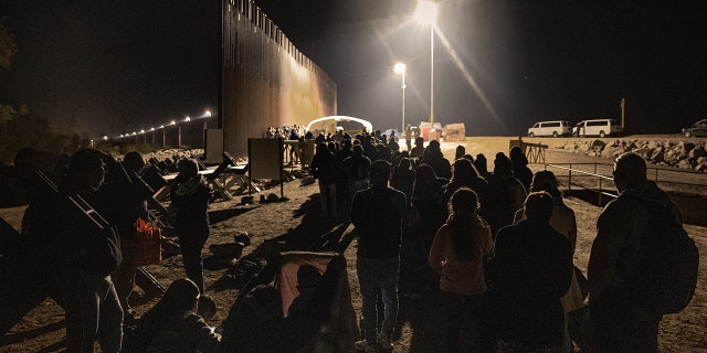 Immigrants wait to be processed by the U.S. Border Patrol after crossing the border from Mexico on December 30, 2022, in Yuma, Arizona. 