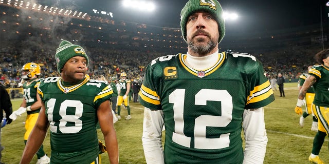 Aaron Rodgers #12 and Randall Cobb #18 of the Green Bay Packers walk off the field after losing to the Detroit Lions at Lambeau Field on January 08, 2023 in Green Bay, Wisconsin.