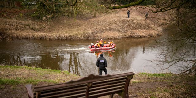 A search dog from Lancashire Police and a crew from Lancashire Fire and Rescue service search the River Wyre on Feb. 1, 2023, in Preston United Kingdom.