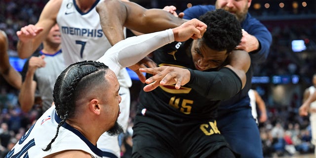 Dillon Brooks, #24 of the Memphis Grizzlies, fights with Donovan Mitchell, #45 of the Cleveland Cavaliers, during the third quarter at Rocket Mortgage Fieldhouse on February 2, 2023, in Cleveland, Ohio.  Both players were ejected.  The Cavaliers defeated the Grizzlies 128-113. 