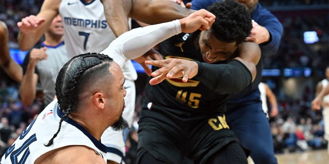 Dillon Brooks, #24 of the Memphis Grizzlies, fights with Donovan Mitchell, #45 of the Cleveland Cavaliers, during the third quarter at Rocket Mortgage Fieldhouse on February 2, 2023, in Cleveland, Ohio. Both players were ejected. The Cavaliers defeated the Grizzlies 128-113.