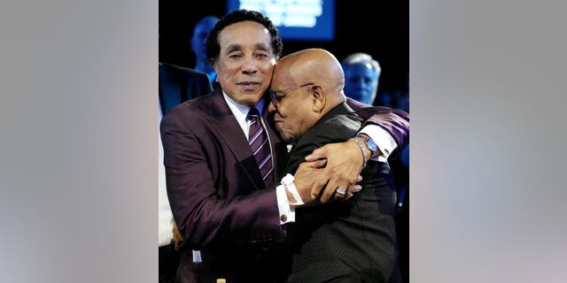Smokey Robinson was embraced by Berry Gordy at the MusiCares Persons of the Year event. 