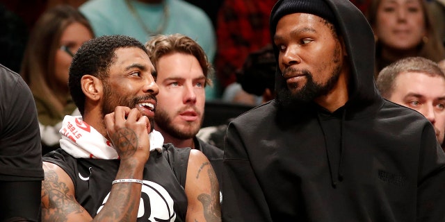 Kyrie Irving #11 (L) and Kevin Durant #7 of the Brooklyn Nets look on against the Los Angeles Lakers at Barclays Center on January 30, 2023 in New York City. 