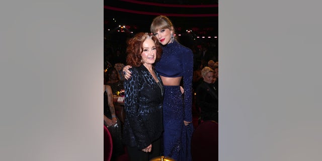 Bonnie Raitt, left, and Taylor Swift pose during the 65th Grammy Awards. Raitt won song of the year over Swift in an unexpected win.