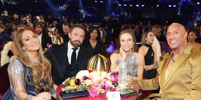 Jennifer Lopez and Ben Affleck were seated next to Dwayne Johnson and his wife Lauren Hashian at the Grammy Awards on Sunday night.