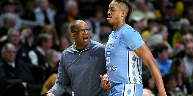 North Carolina Tar Heels head coach Hubert Davis talks with Armando Bacot, #5, during the first half of their game against the Wake Forest Demon Deacons at Lawrence Joel Veterans Memorial Coliseum on Feb. 7, 2023 in Winston-Salem, North Carolina.