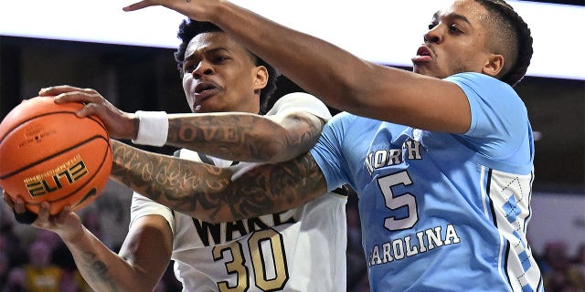 Damari Monsanto, #30 of the Wake Forest Demon Deacons, and Armando Bacot, #5 of the North Carolina Tar Heels, vie for a rebound during the second half of their game at Lawrence Joel Veterans Memorial Coliseum on Feb. 7, 2023 in Winston-Salem, North Carolina. Wake Forest won 92-85, 