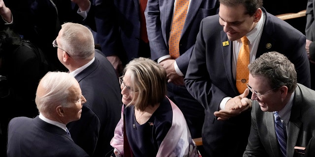 Rep. George Santos, R-NY, watches as President Biden greets members of Congress after his State of the Union address during a joint meeting of Congress in the House Chamber of the U.S. Capitol on February 07, 2023, in Washington, DC.
