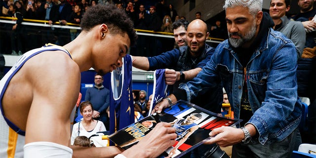 Victor Wembanyama, #1 of Boulogne-Levallois Metropolitans 92, signs autographs after the match between Boulogne-Levallois and JDA Dijon at Palais des Sports Marcel Cerdan on February 10, 2023 in Levallois-Perret, France. 
