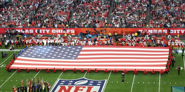 Chris Stapleton performs the national anthem alongside Troy Kotsur performing in American Sign Language before Super Bowl LVII between the Kansas City Chiefs and the Philadelphia Eagles at State Farm Stadium on February 12, 2023 in Glendale, Arizona. 