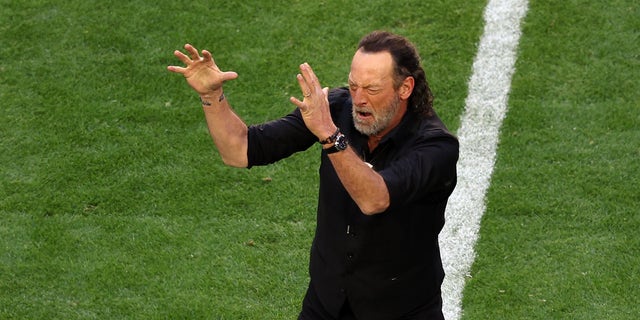 "CODA" star Troy Kotsur signs the national anthem before Super Bowl LVII.