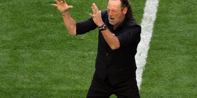"CODA" star Troy Kotsur signs the national anthem before Super Bowl LVII.