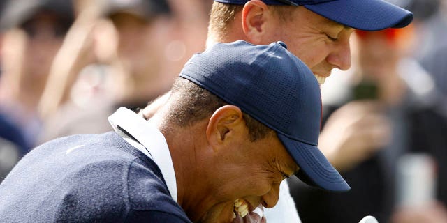 Tiger Woods of the United States and Justin Thomas of the United States walk across the ninth hole during the first round of the The Genesis Invitational at Riviera Country Club on February 16, 2023 in Pacific Palisades, California.