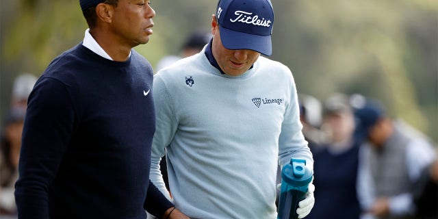 Tiger Woods and Justin Thomas tee off the 9th tee during the Genesis Invitational on February 16, 2023.