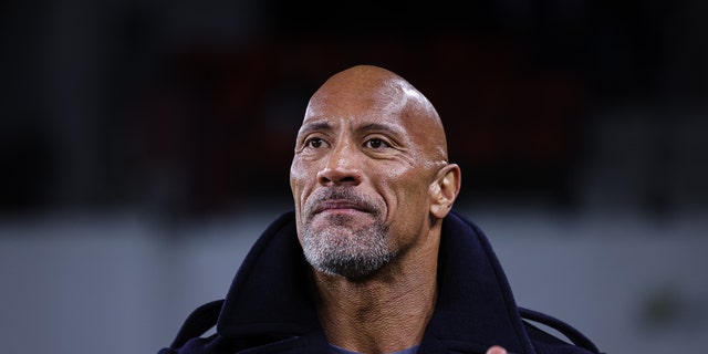 Dwayne Johnson, one of the co-owners of the XFL, enjoys a game between the DC Defenders and the Seattle Sea Dragons earlier this month.