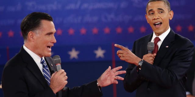Republican presidential candidate Mitt Romney (L) and U.S. President Barack Obama talk over each other as they answer questions during a town hall style debate at Hofstra University October 16, 2012, in Hempstead, New York.