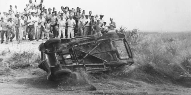 Fans react in 1940 as a driver rolls his car during a stock car race on the Daytona Beach-Road Course. Three races were held on the beach that year and were won by Roy Hall, Bill France (later the founder of NASCAR) and Buck Mathis. A special "ladies only" race was also held; it attracted 13 contestants, including France’s wife Anne. Evelyn Reed won the event. 