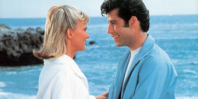 Olivia Newton-John and John Travolta on the beach while filmnig "Grease"